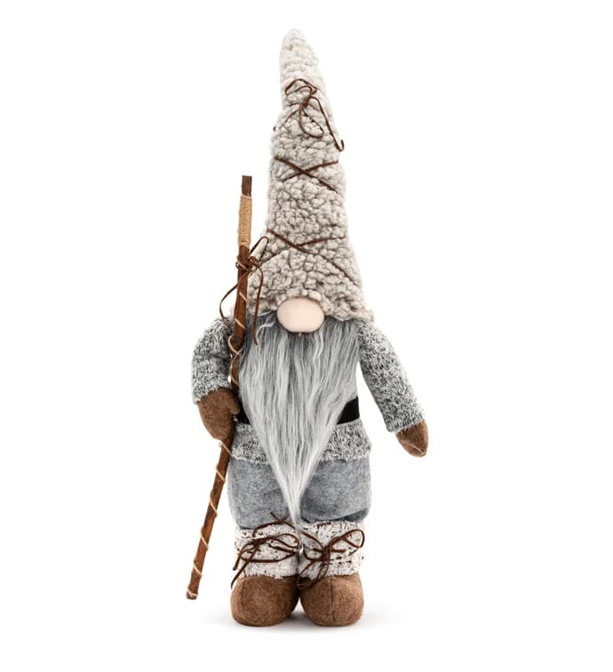 Plush gnome figurine with a tall hat and staff on a white background