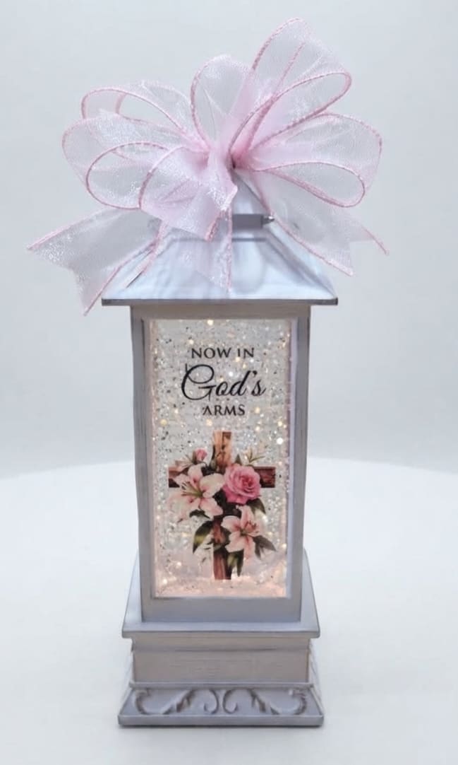 Decorative lantern with a pink bow and floral print panel