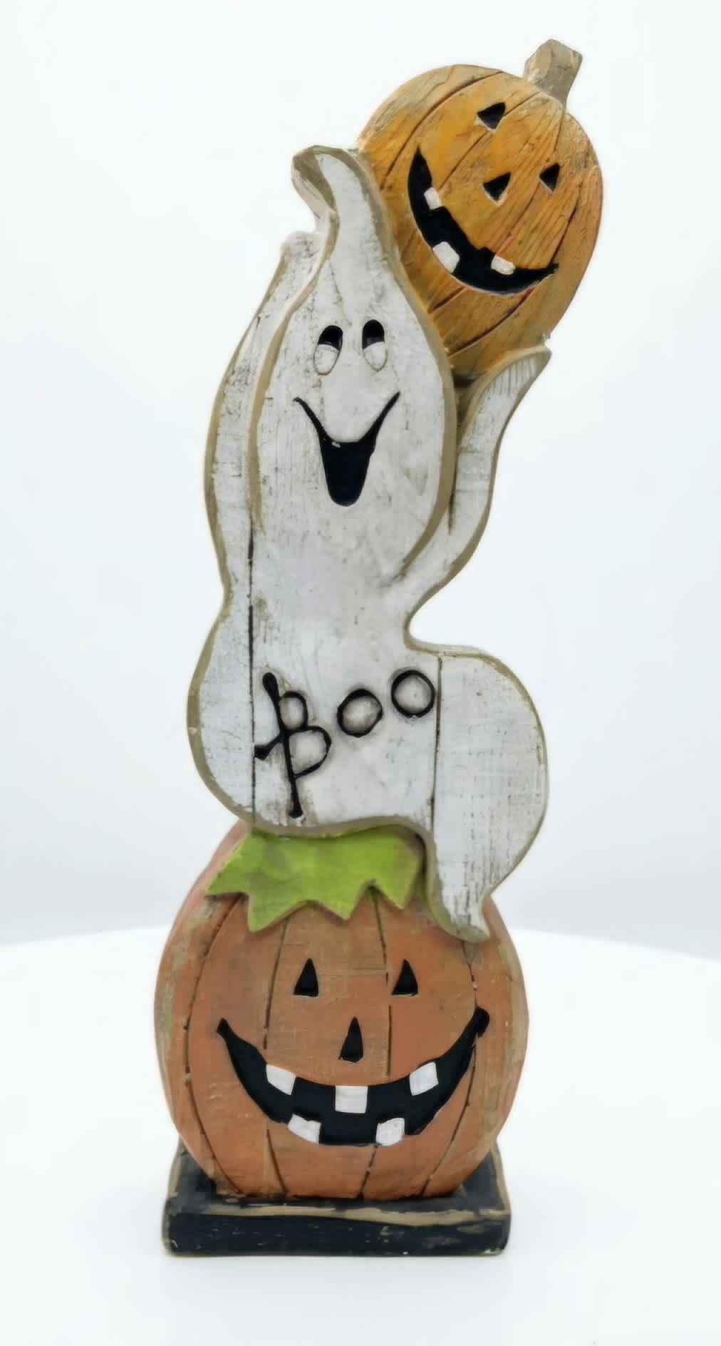 Wooden Halloween ghost and pumpkin stack figurine on a base