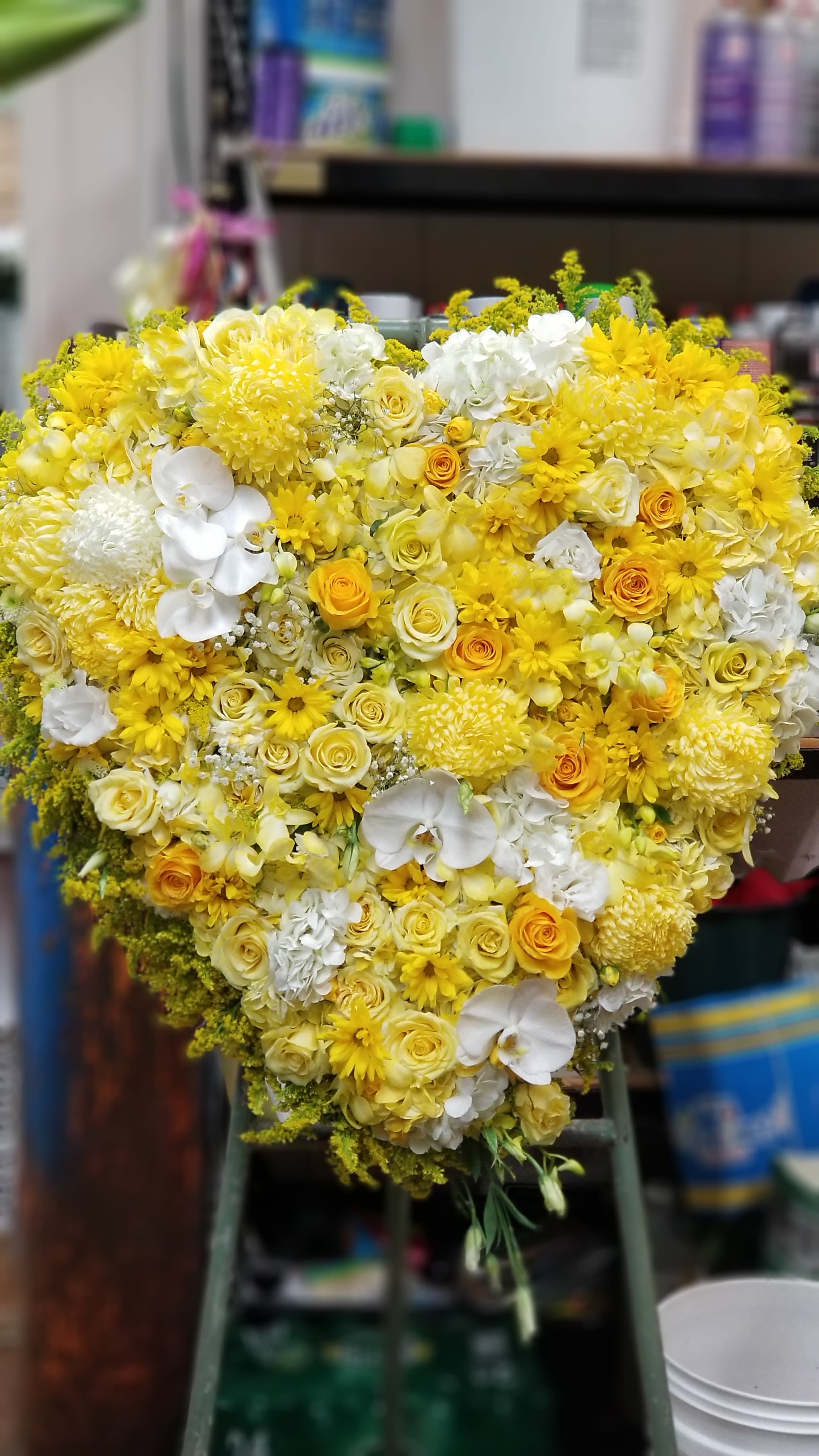 Heart-shaped bouquet of yellow and white flowers