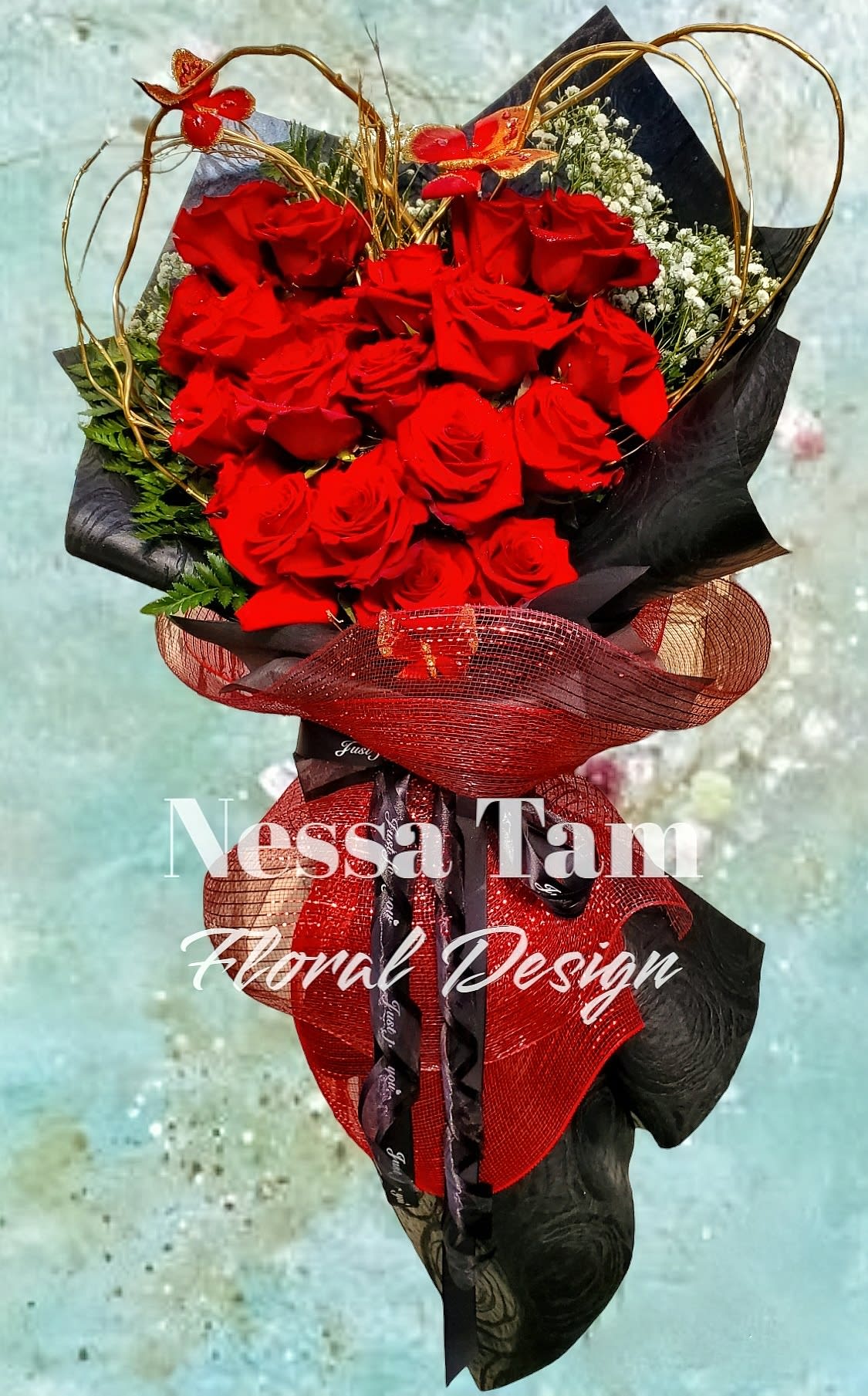 Bouquet of red roses with baby's breath and decorative gold loops
