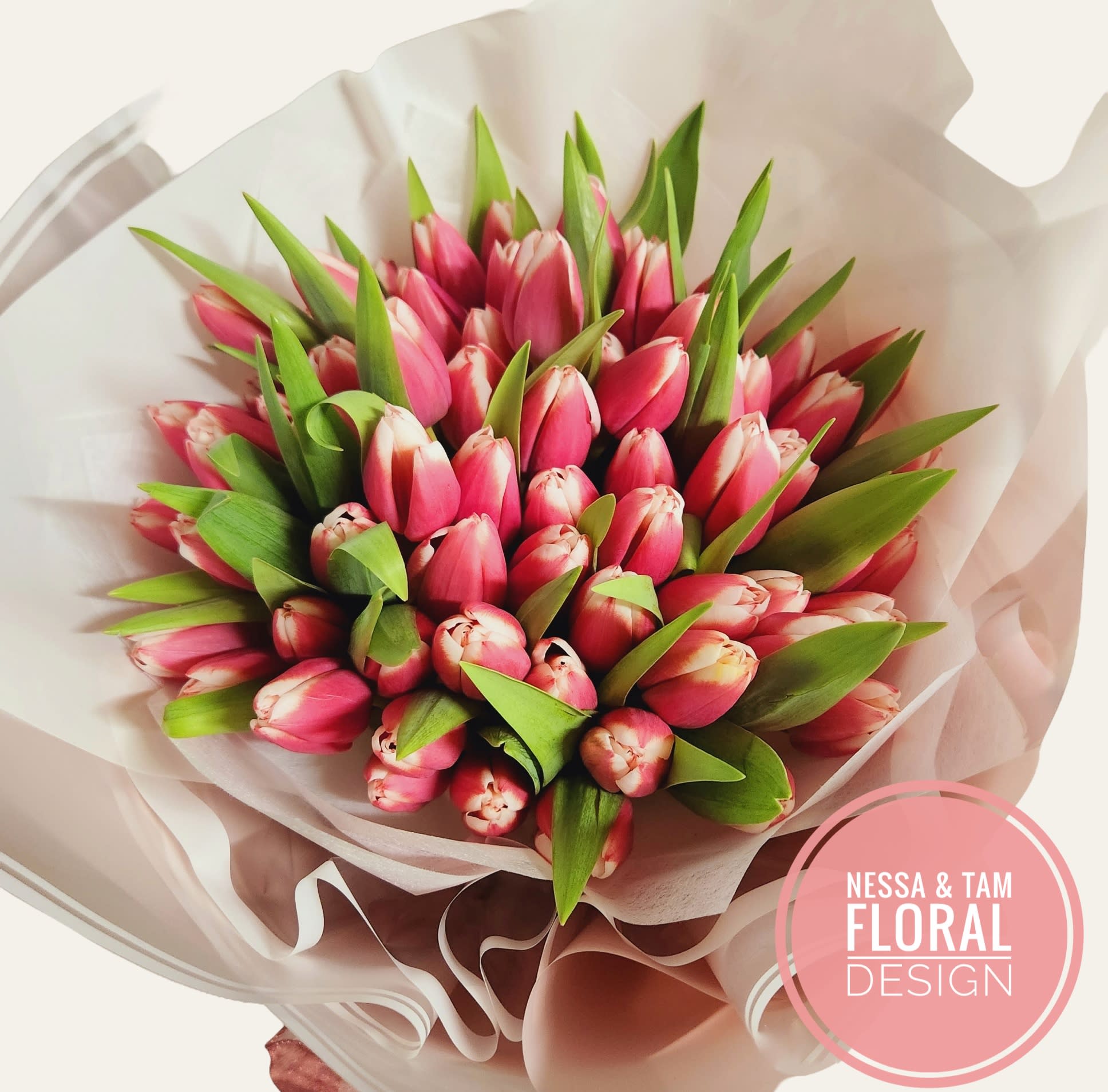 Bouquet of pink tulips wrapped in pale paper