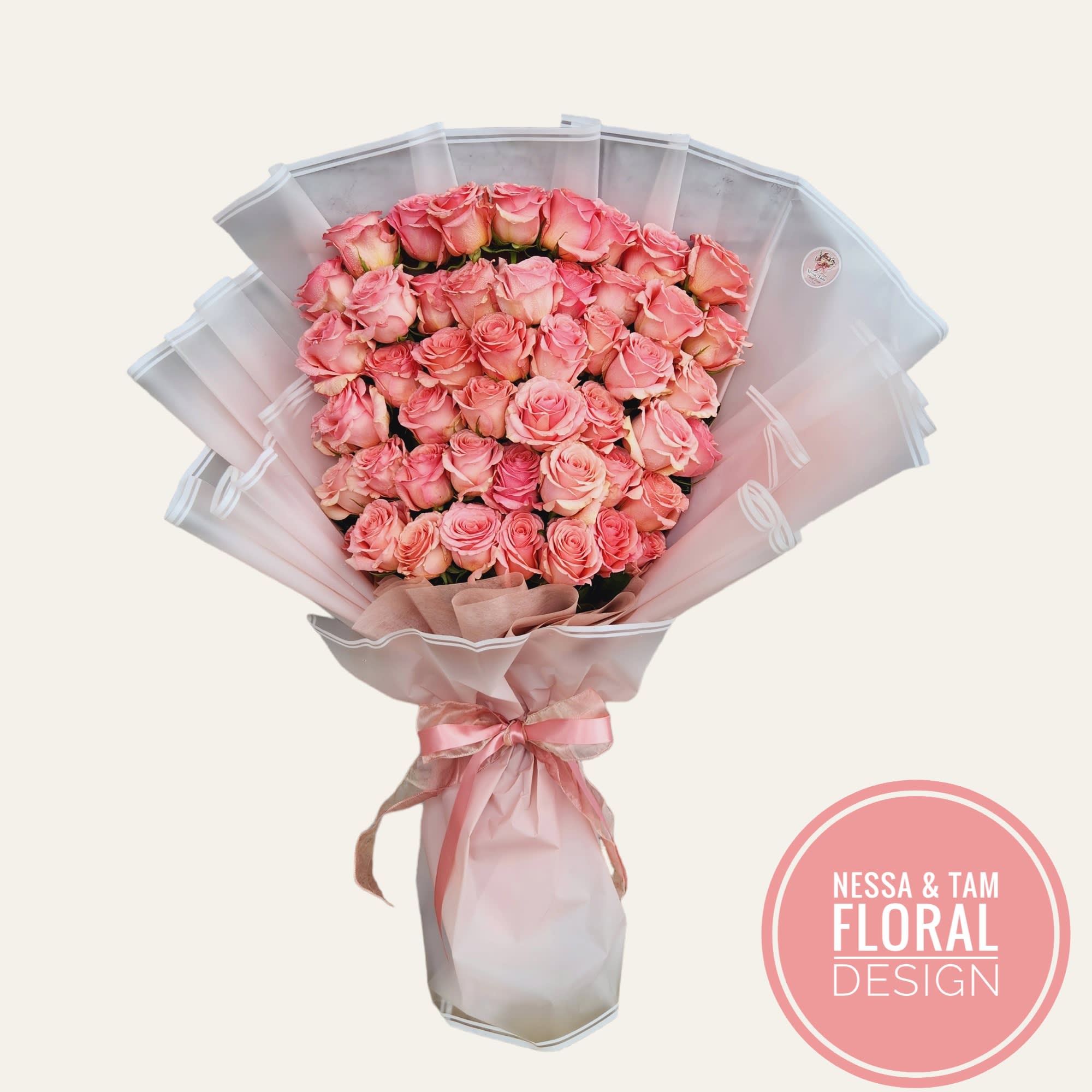 Large bouquet of pink roses wrapped in pale pink paper