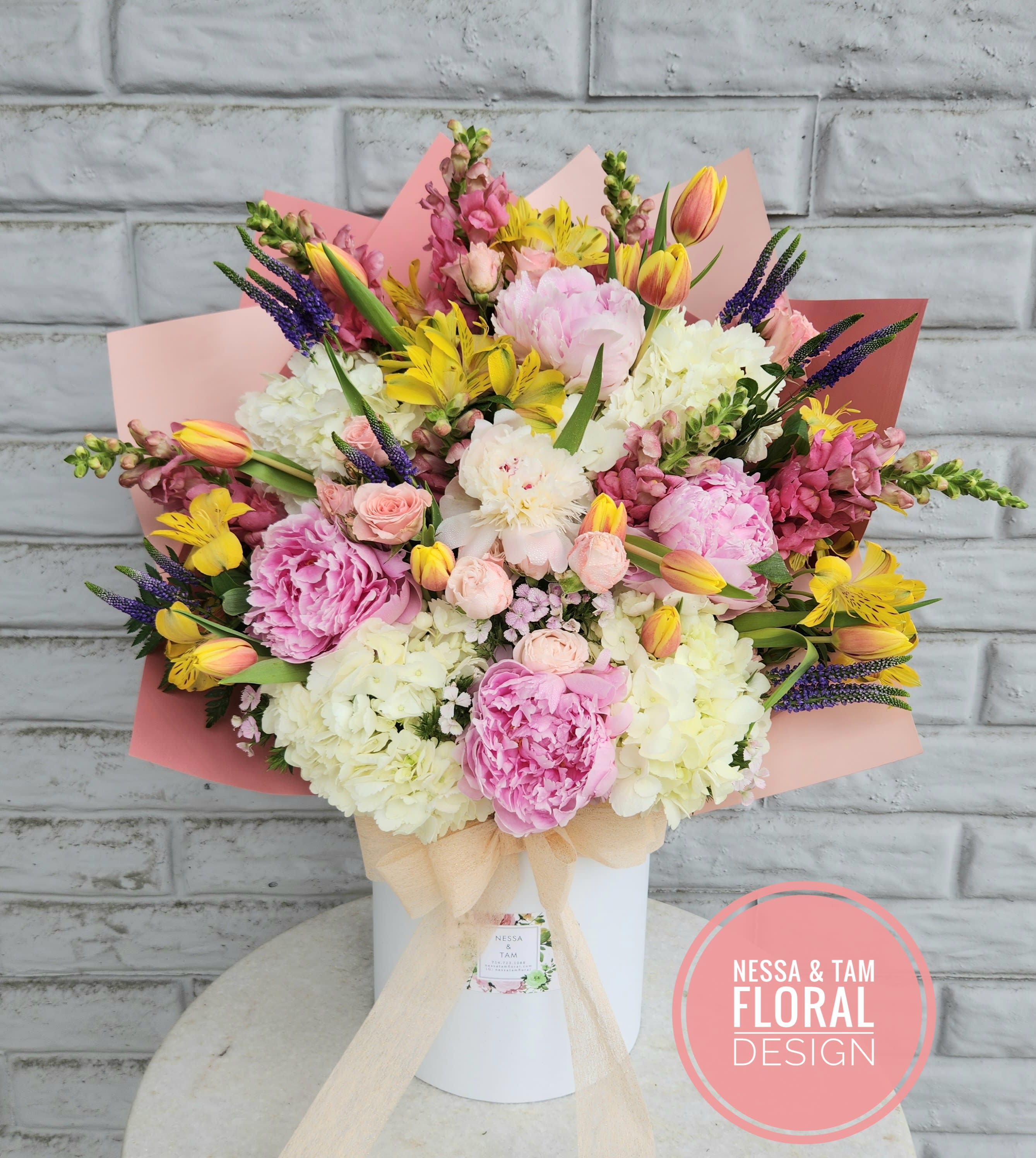 Large pastel bouquet in a white box with pink wrapping