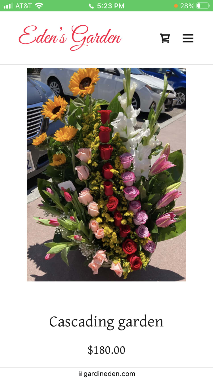 Cascading floral arrangement with sunflowers, roses, lilies, and tulips