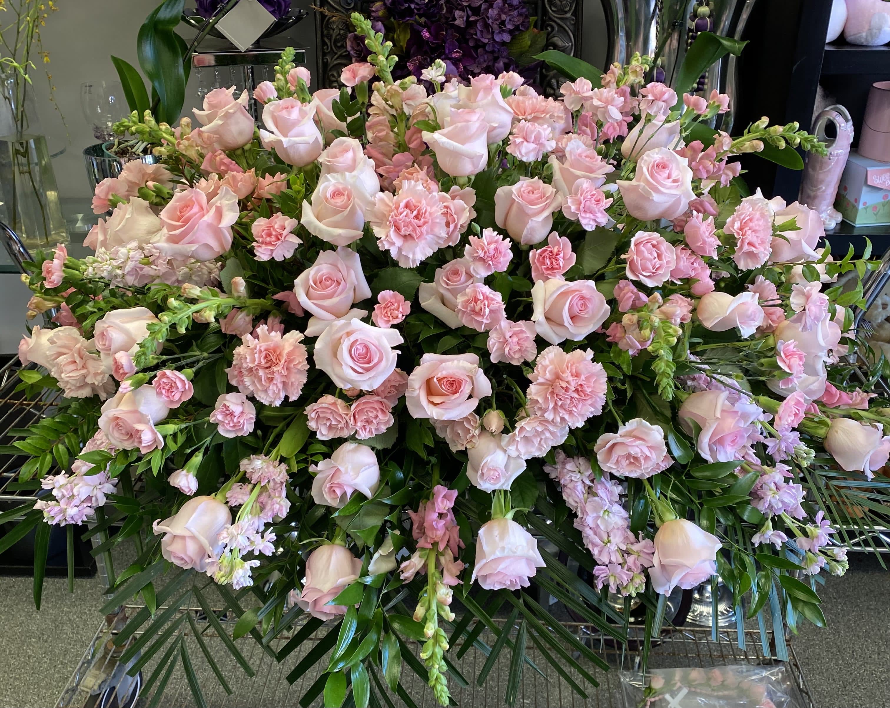 Large pink rose and carnation floral spray with greenery