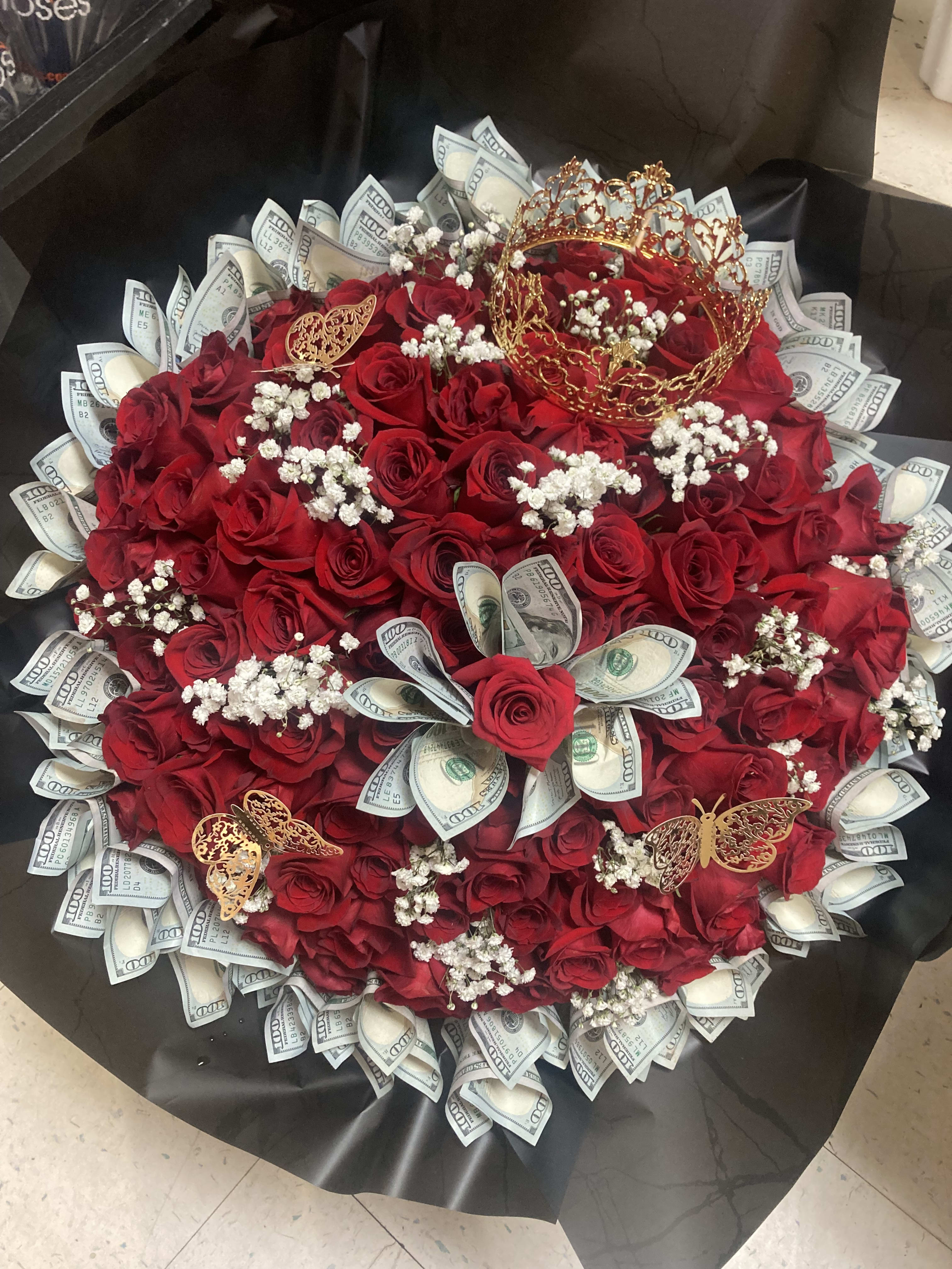 Bouquet of red roses with dollar bills and gold butterfly accents