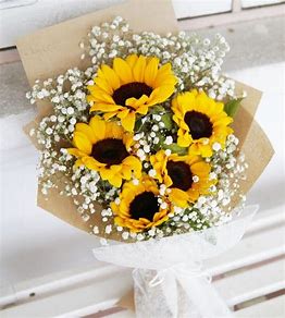 Bouquet of yellow sunflowers with white baby's breath in kraft paper