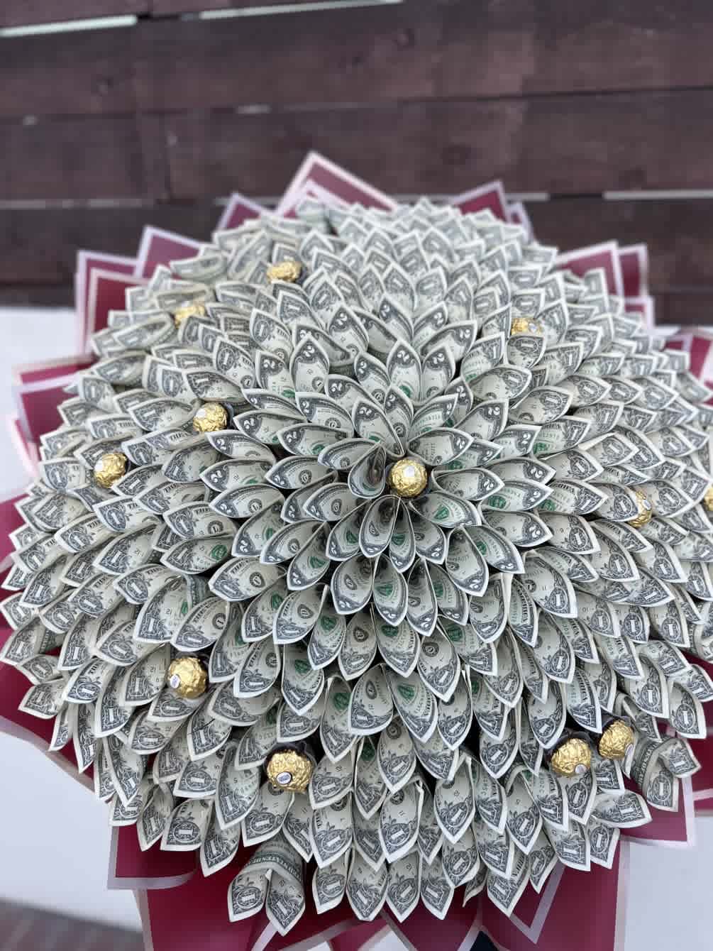 Bouquet made of folded dollar bills with gold-wrapped chocolates