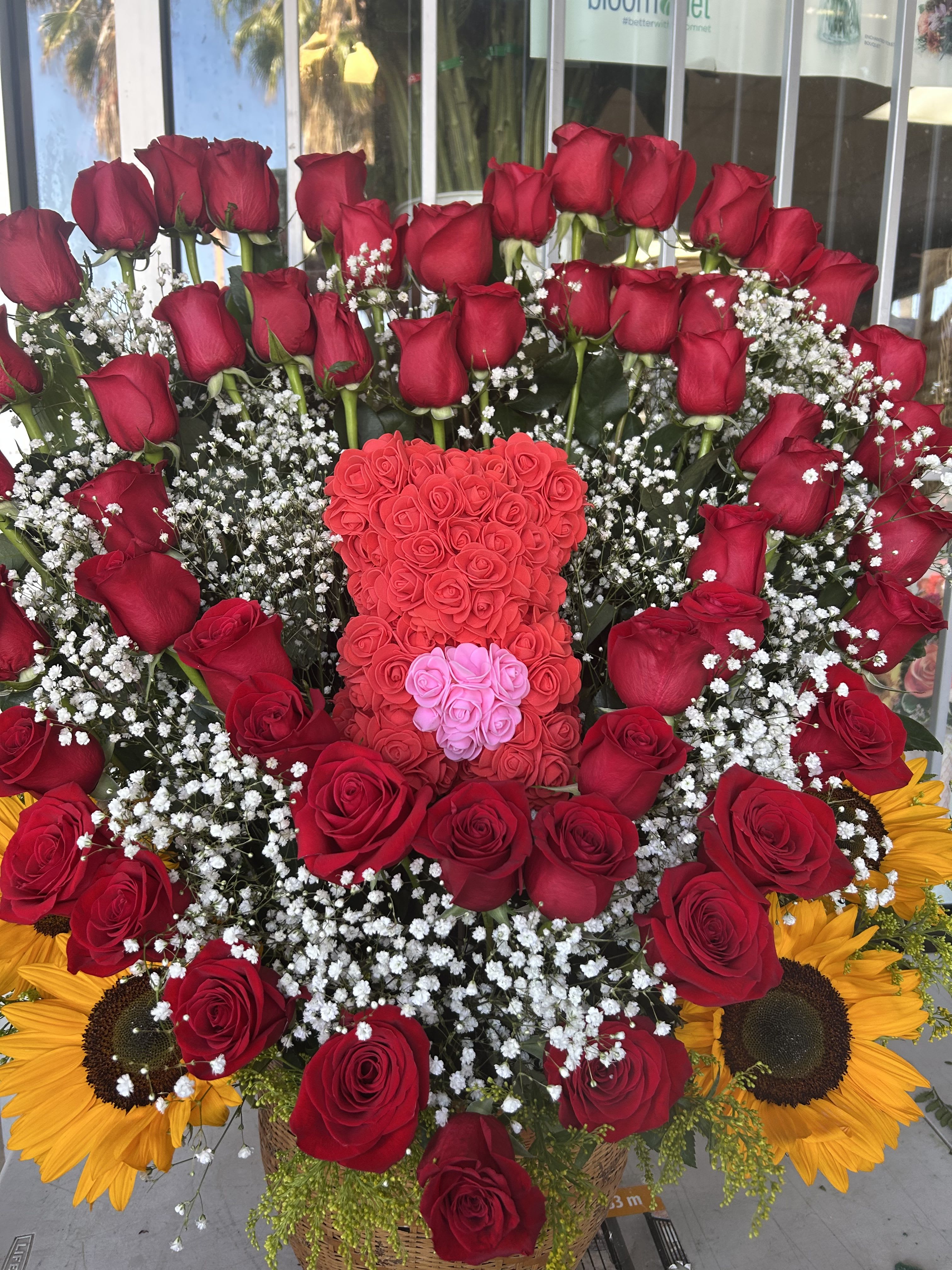 Large bouquet of red roses with baby’s breath and sunflowers