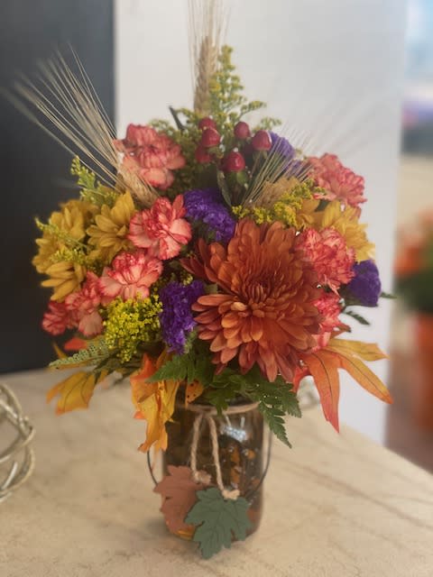 Autumn Cutie - Mixed fall flowers displayed in mason jar.