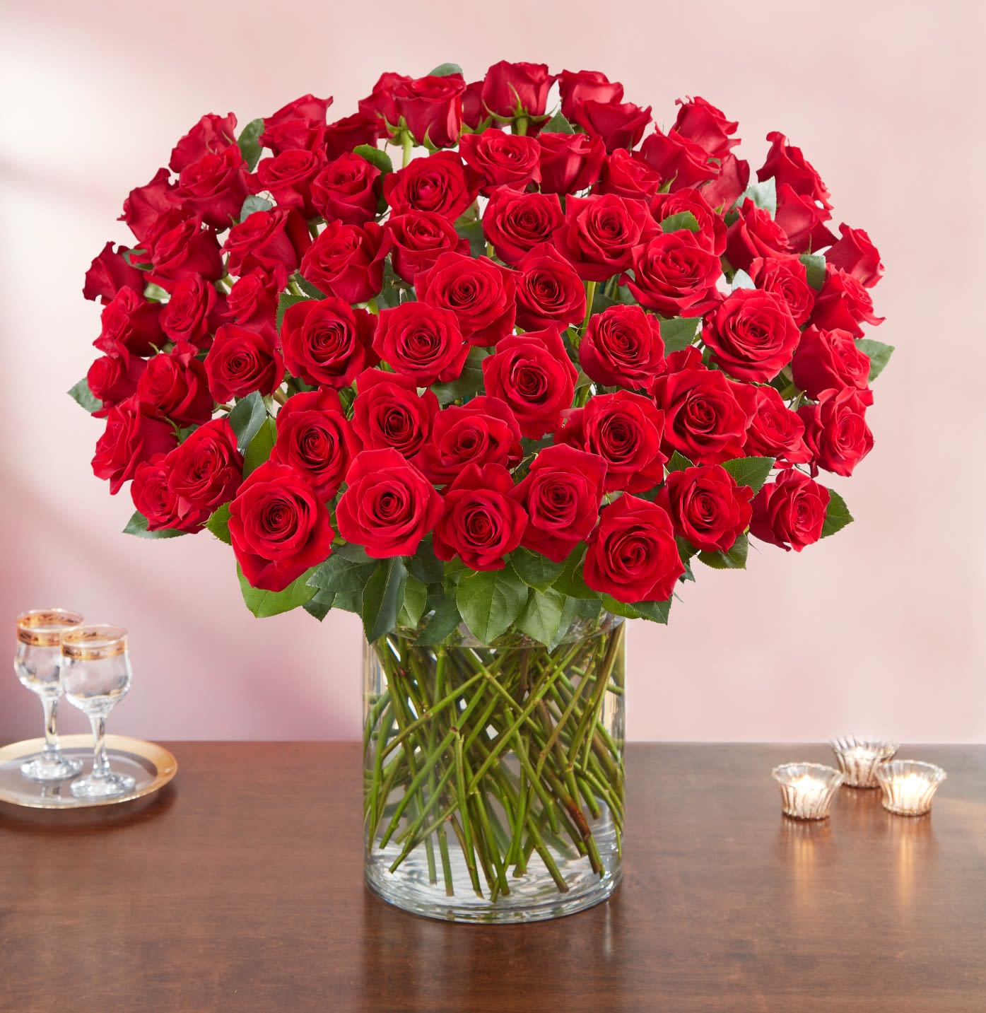100 Premium Long Stem Red Roses - Wow the one you love like never before with 100 stunning long stem red roses! Our spectacular arrangement is artistically designed by our expert floral artisans with an abundant array of dazzling red blooms and lush greenery inside a classic cylinder vase. Standing over 2 feet tall, this luxurious surprise is personally hand-delivered for a grand romantic gesture she’ll remember always.