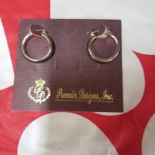 Pair of gold hoop earrings on a branded display card