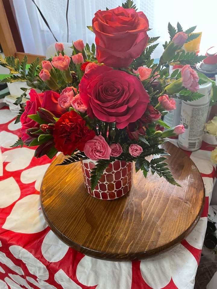 Red and pink rose bouquet in a patterned vase