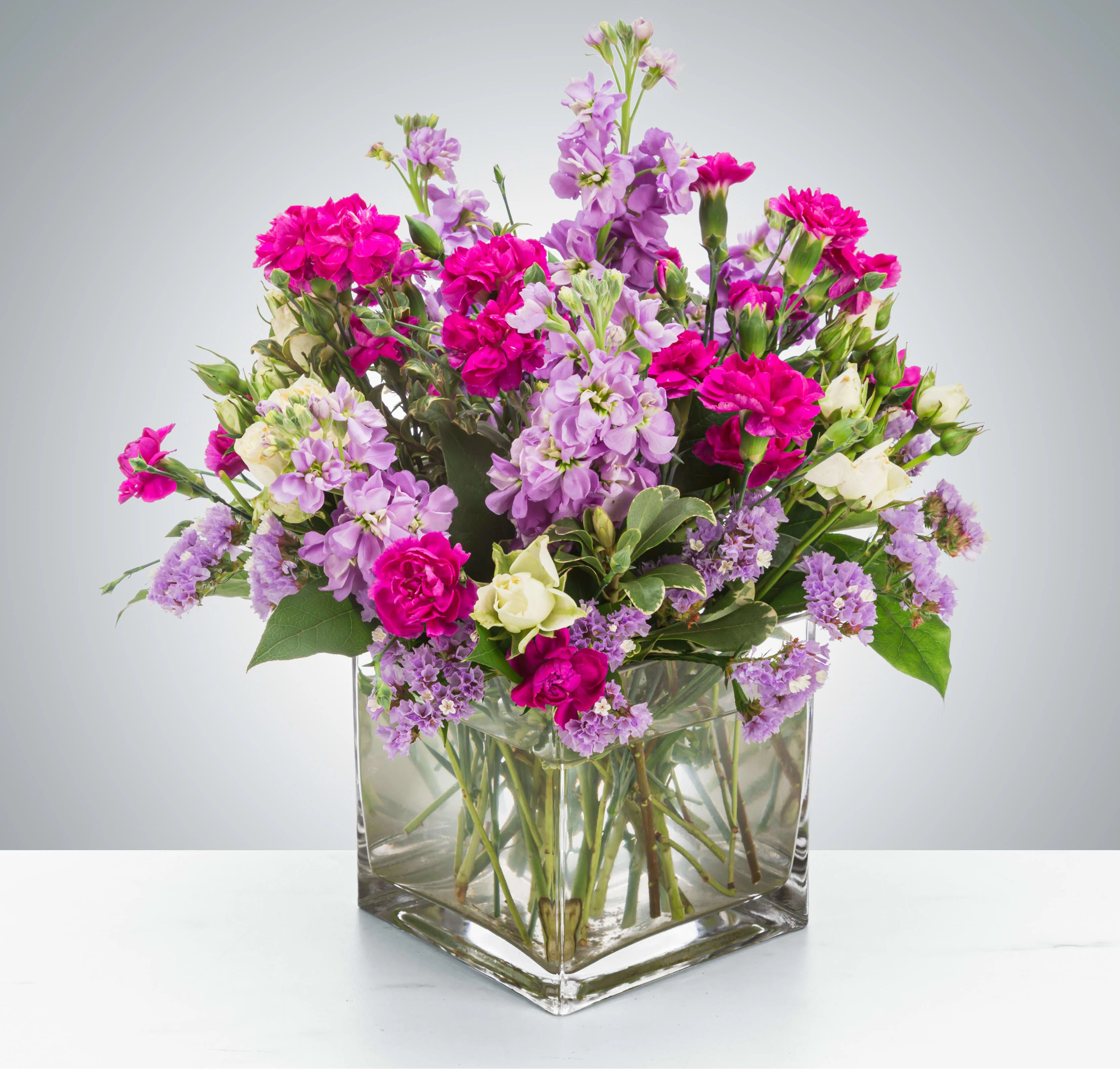 Twist and Shout by BloomNation™ - Flowers are fun! Especially when they look like this! Featuring sweet-smelling stock, spray roses, and carnations, this arrangement is a great surprise for Best Friends Day, Sister Day, or just because.  Approximate Dimensions: 10"D x 10"H