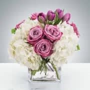 Here for You by BloomNation™ - Express your condolences after the loss of a loved one with flowers. Sending this clean purple and white arrangement featuring lavender roses and white hydrangea is a way to show you care and are thinking of them.  Approximate Dimensions: 11"D x 11"H