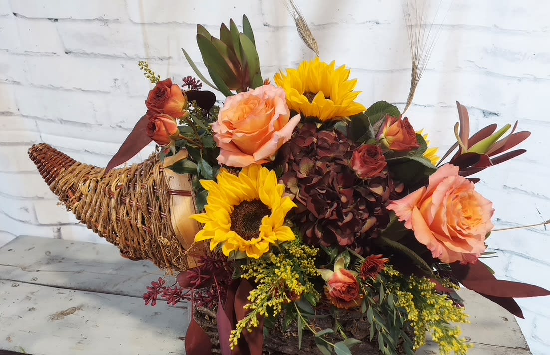 Bloom's Harvest - For the holiday season, this harvest of plenty is overflowing with beautiful seasonal blooms.  Delight your guests with this festive display for your holiday table