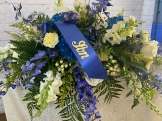 Large blue and white floral spray with a ribbon