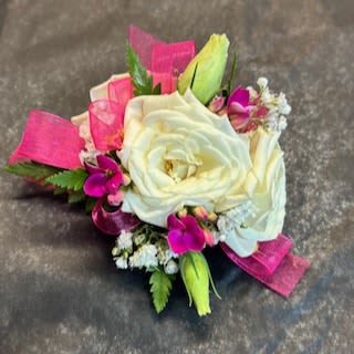 White rose boutonniere with pink accents and ribbon