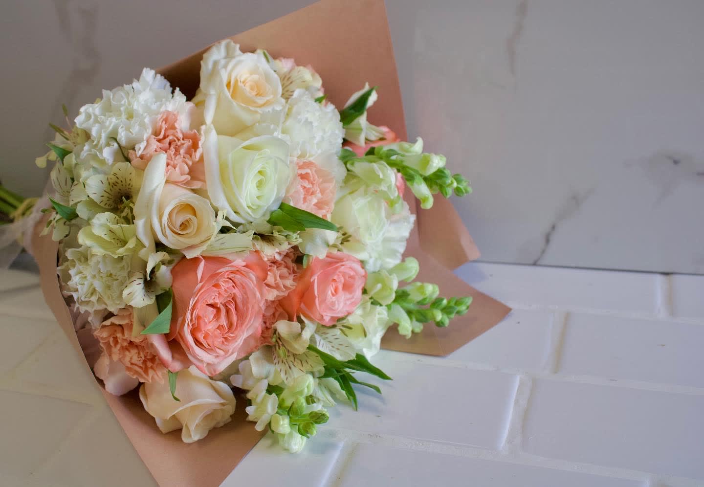 Bouquet of peach and white roses with white carnations and alstroemeria