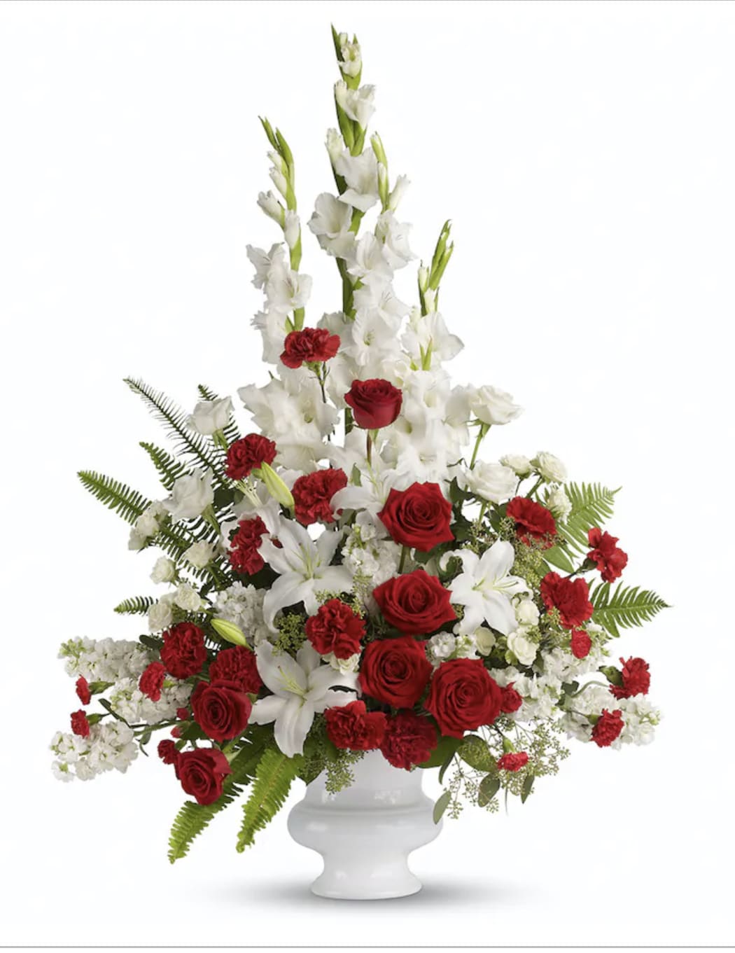 Red roses and white lilies in a white pedestal vase