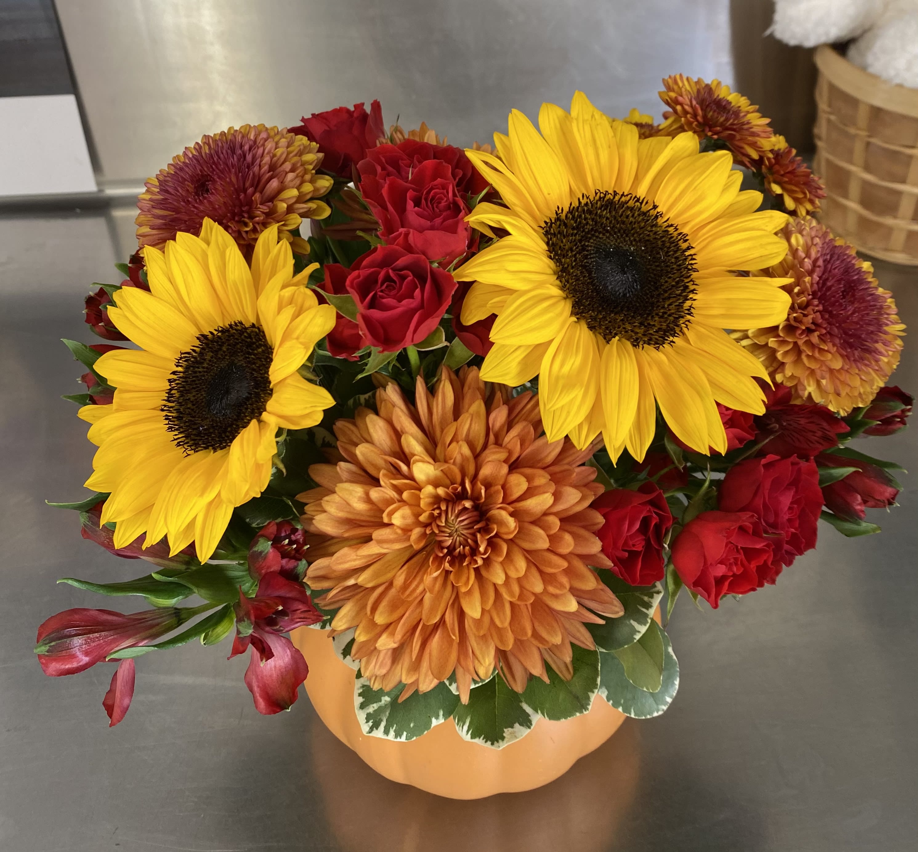 Pumpkin Blooms - Combine the fall blooms with this wonderful pumpkin seasonal arrangement. Housed in a ceramic pumpkin vase, you will surely “fall” in love with this collection of fall flowers.