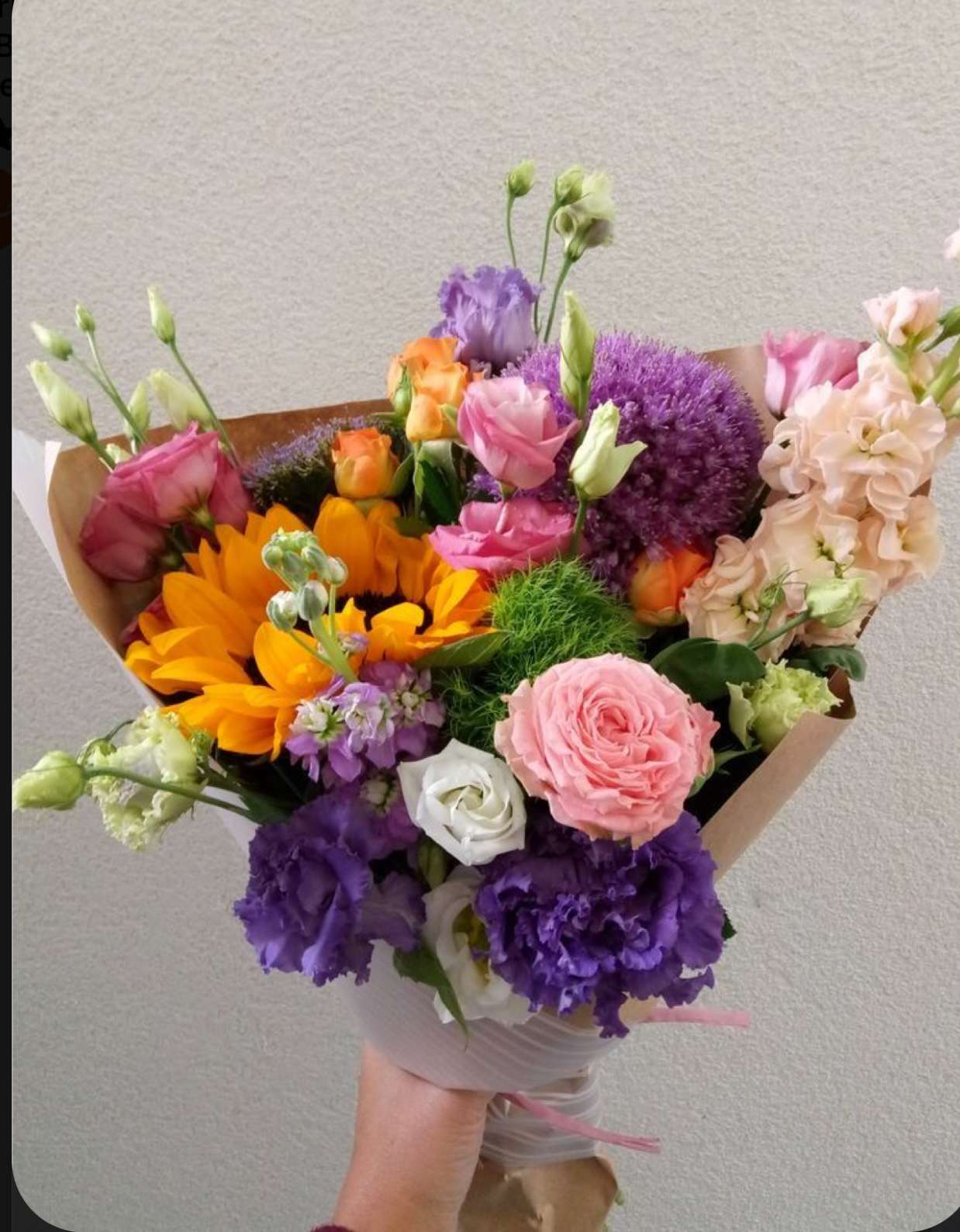 Hand-tied bouquet of pink, purple, orange, and white flowers