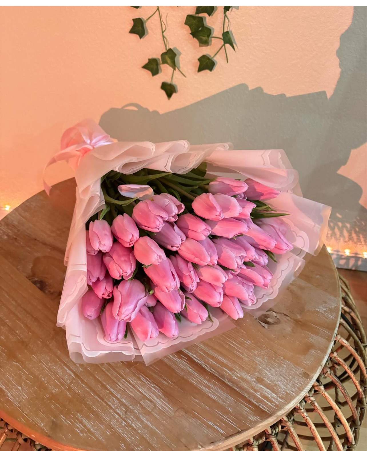 Bouquet of pink tulips wrapped in pale pink paper