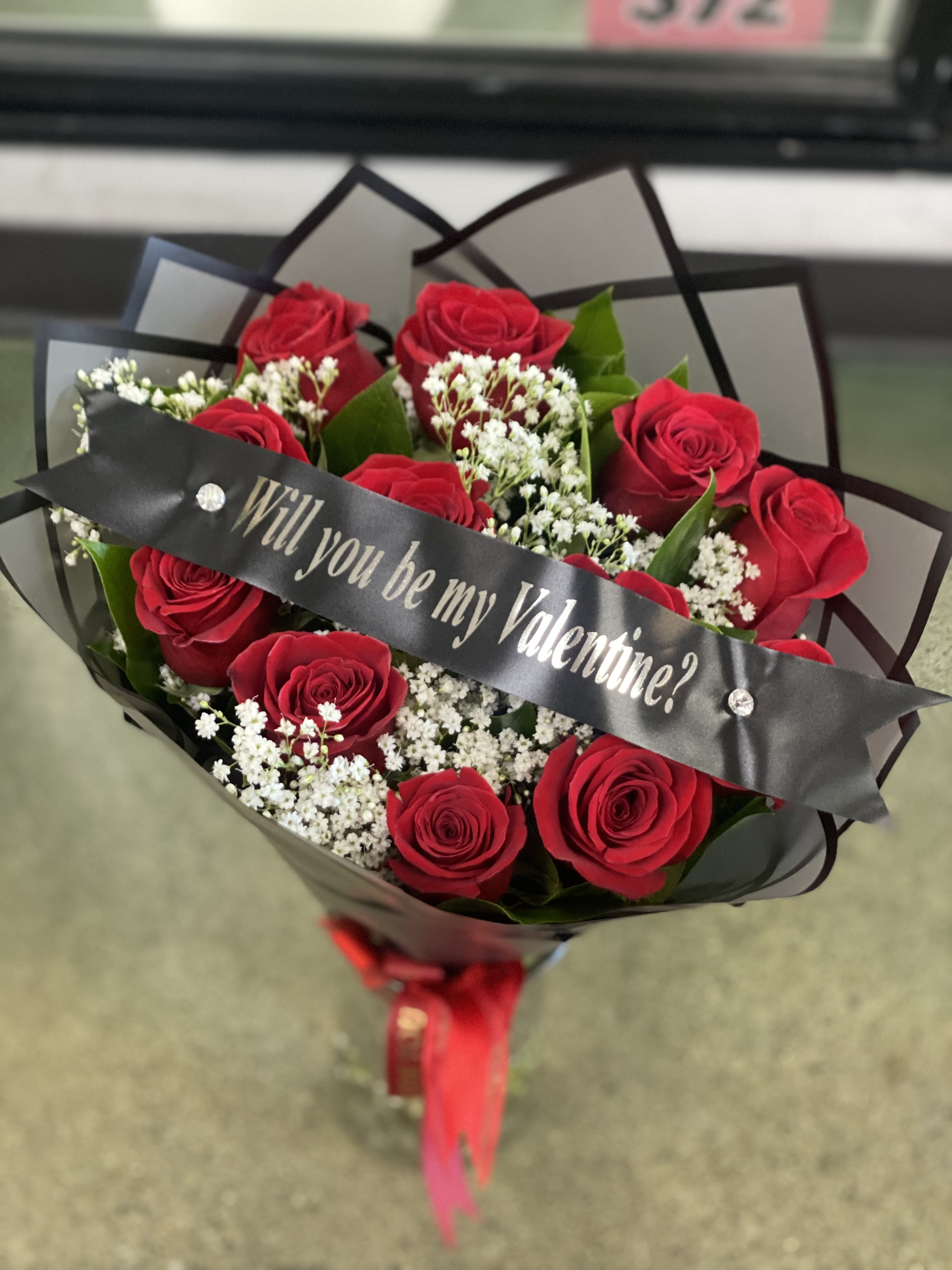 Bouquet of red roses with a Valentine ribbon