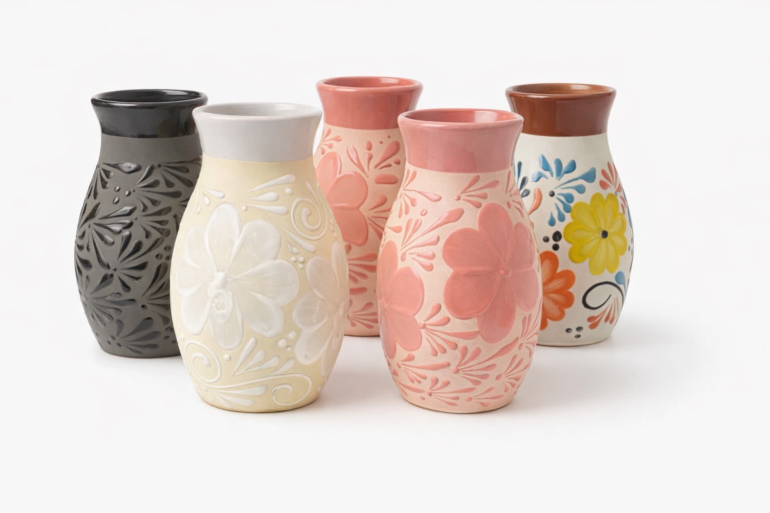 Five decorative ceramic vases with floral patterns in assorted colors