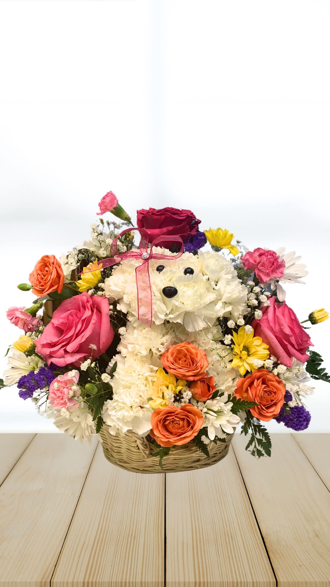 Basket arrangement with a teddy bear made of white flowers and colorful roses