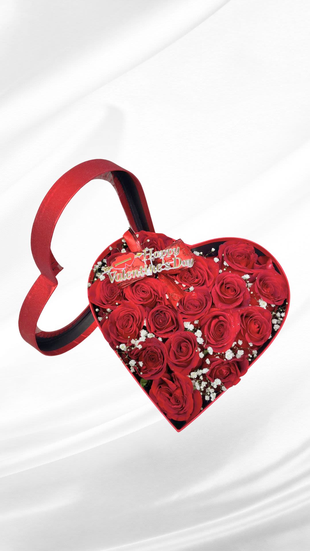 Heart-shaped box of red roses with a Valentine's Day topper