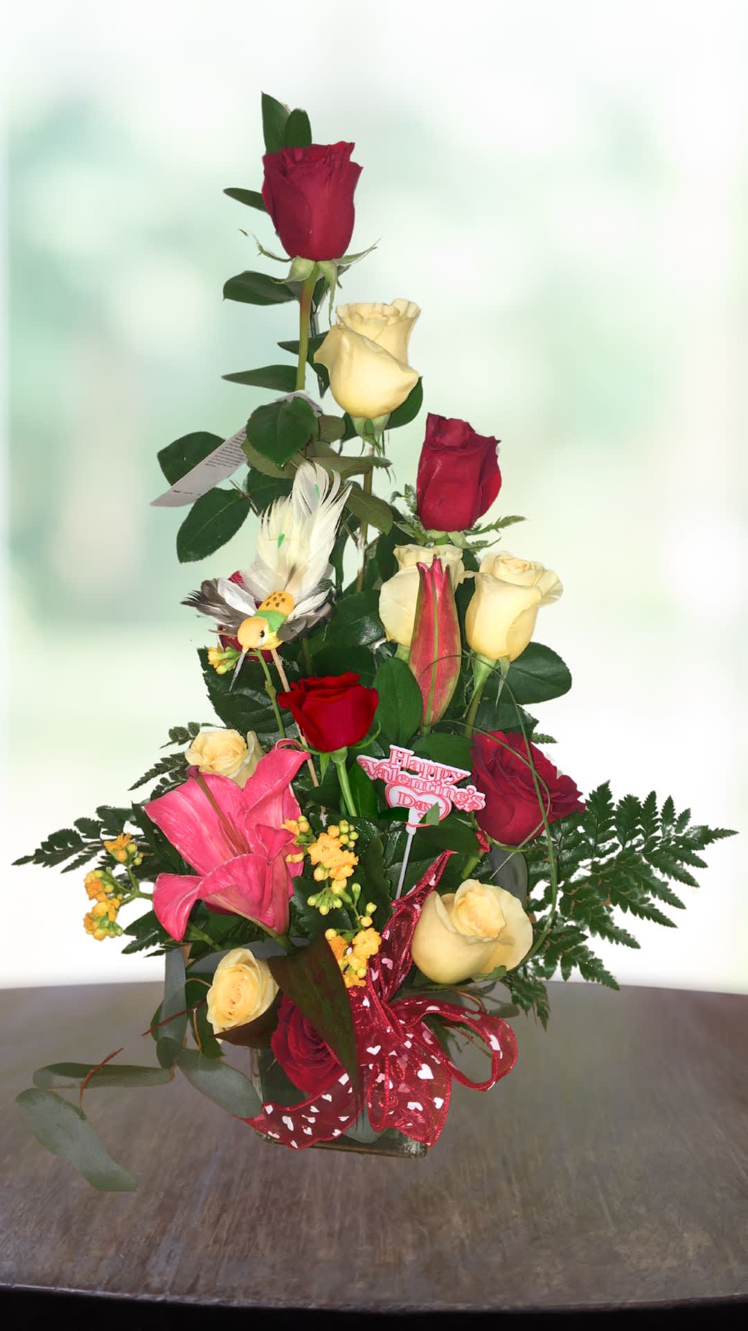 Tall bouquet of red and yellow roses with pink lilies and a Valentine pick