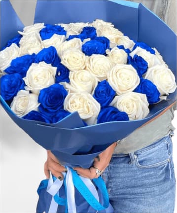 Bouquet of blue and white roses wrapped in blue paper
