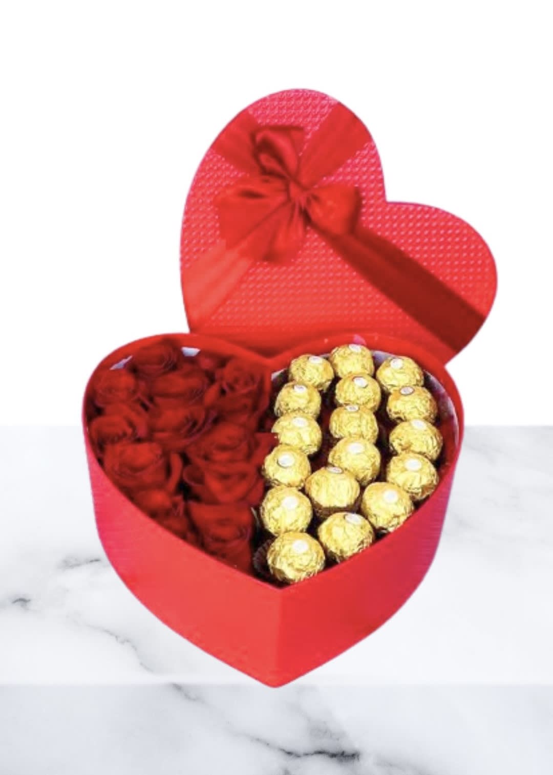Heart-shaped red gift box with red roses and gold-wrapped chocolates