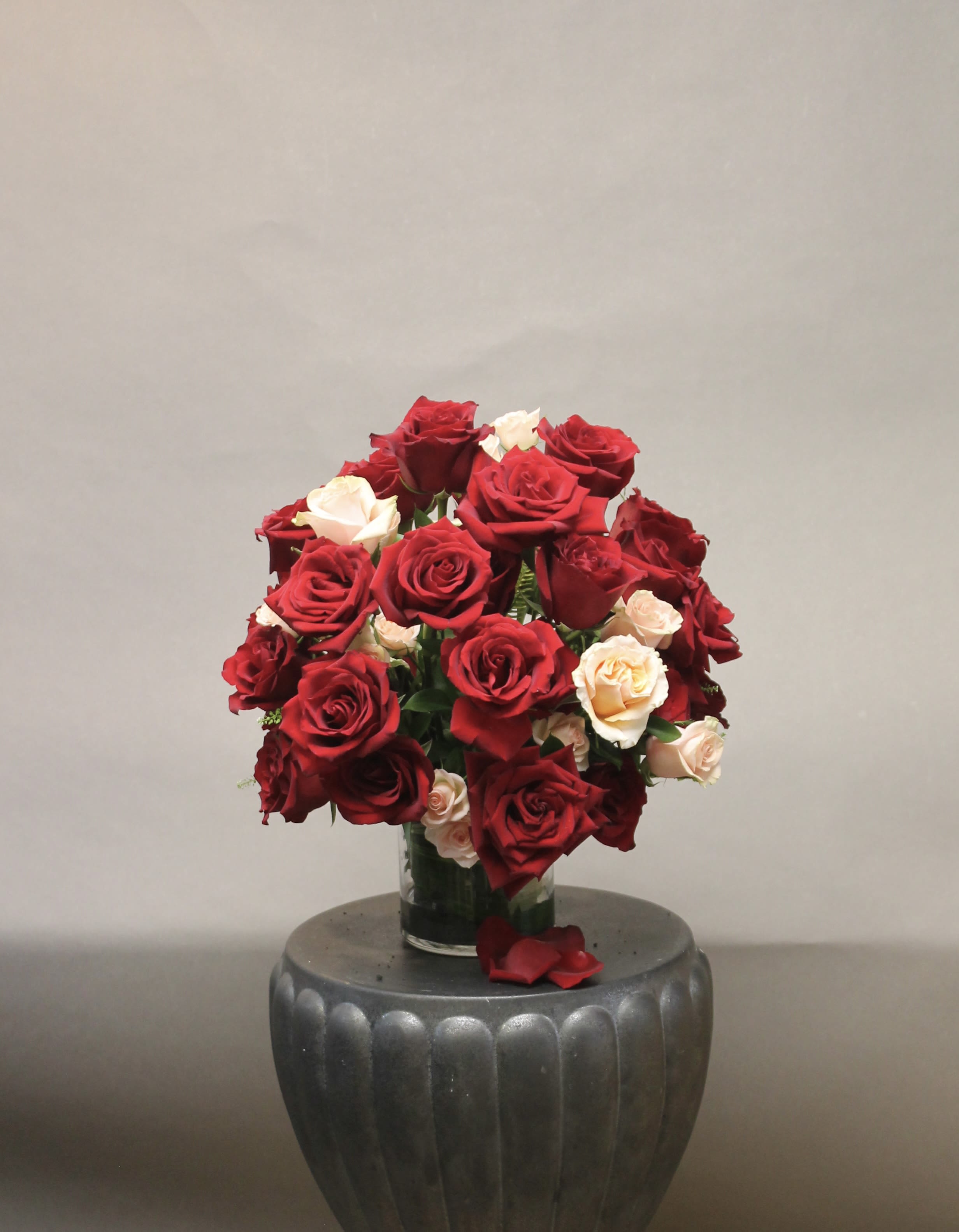 Bouquet of red and cream roses in a glass vase