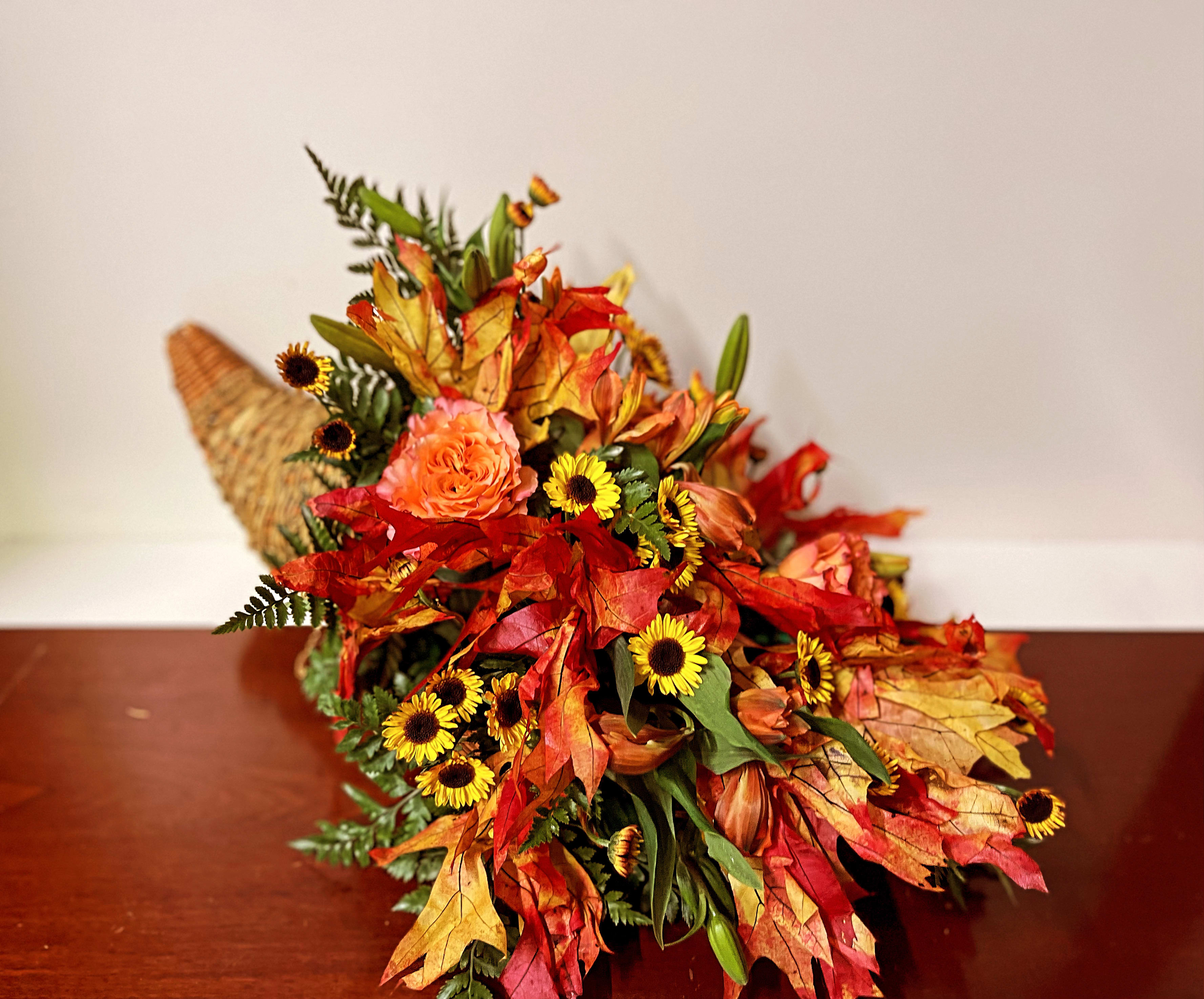 Autumn bouquet with orange roses and yellow daisy-like flowers