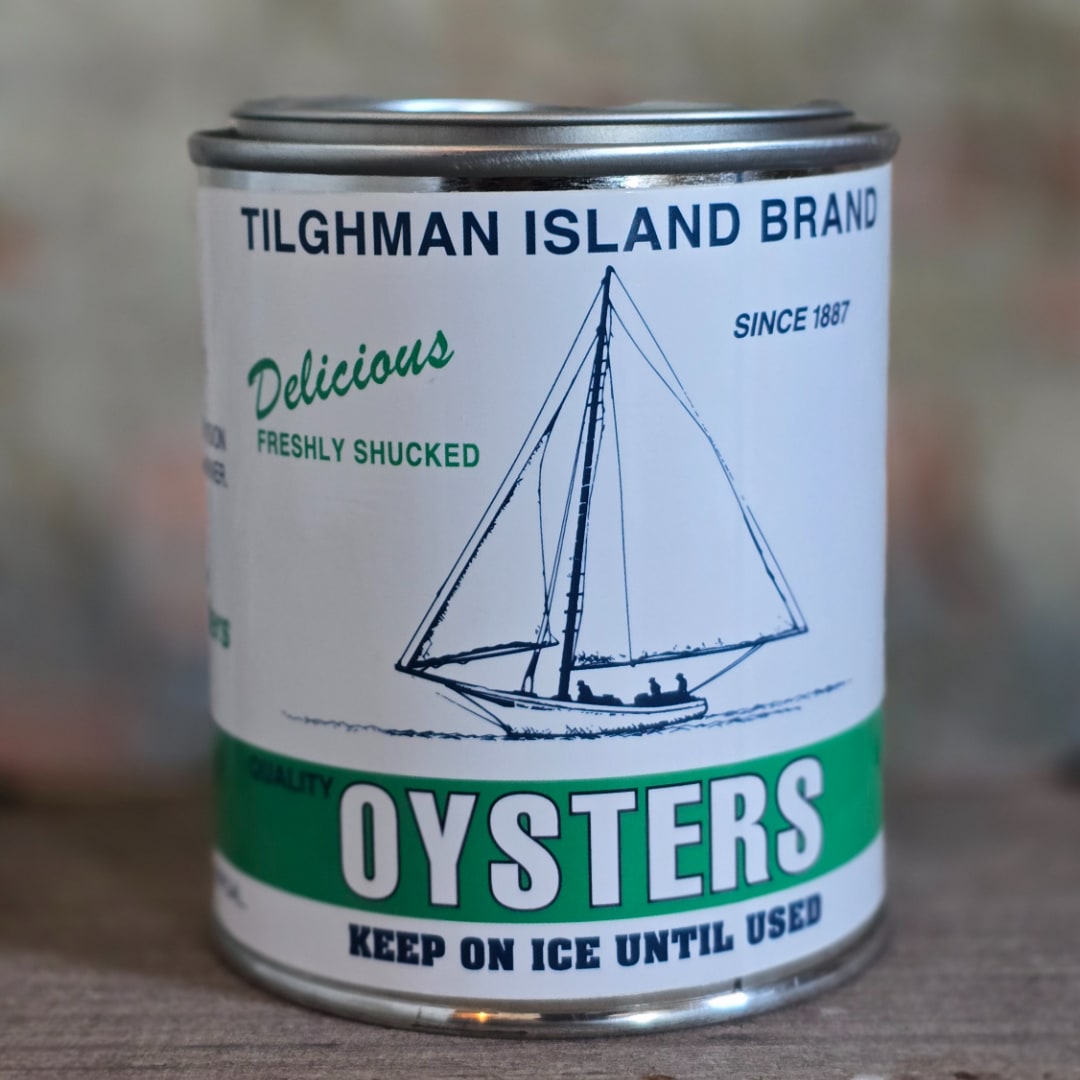Can of oysters with a sailboat label on a table