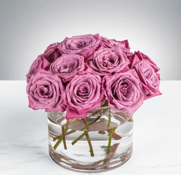 Enchanted Love by BloomNation™ - This beautiful lavender bouquet are guaranteed to brighten someone's day. Enchanted Love by BloomNation™ is perfect for someone's birthday or for anyone that needs cheering up.   Arrangement Details:  Dozen Lavender Roses APPROXIMATE DIMENSIONS:  10"D X 10"H