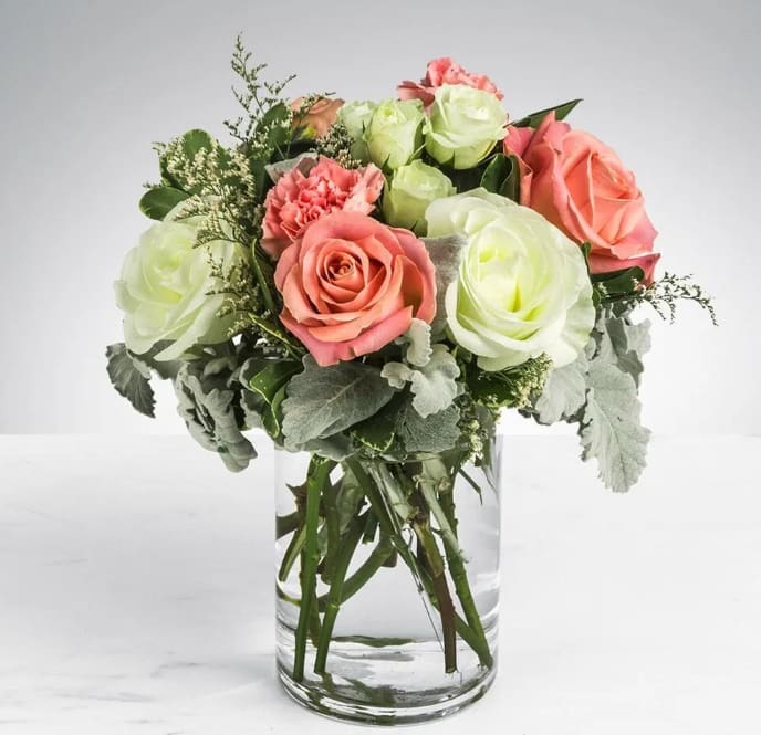 Sweet &amp; Subtle by BloomNation™ - This arrangement includes pink roses, white roses, white spray roses, pink carnations, and dusty miller. Sweet &amp; Subtle by BloomNation™ is the perfect gift for a birthday, thank you, or just because.   APPROXIMATE DIMENSIONS: 9" H X 10" W