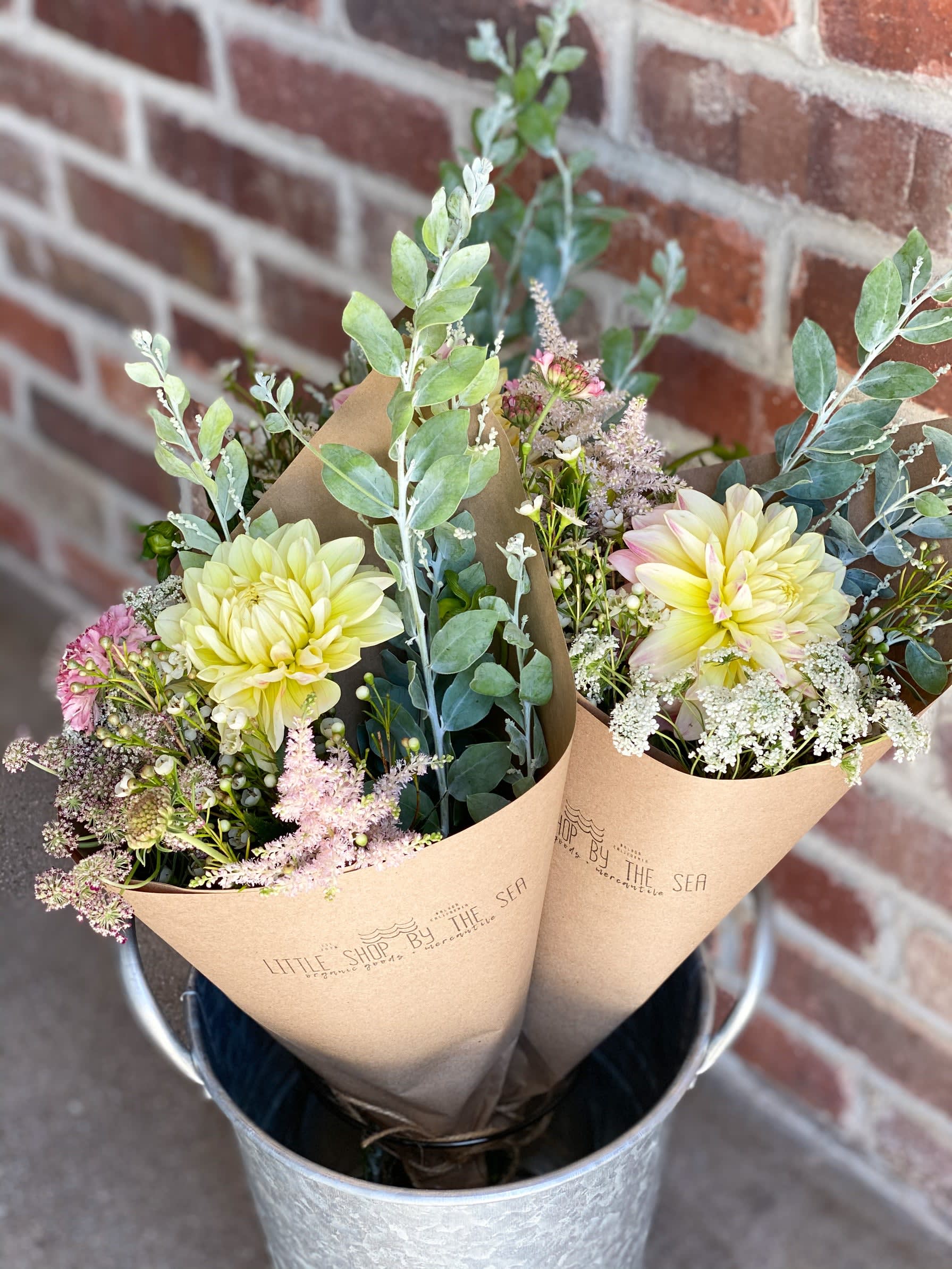 Paper Wrapped Seasonal Bouquet - Enjoy our signature paper wrapped style, hand tied and filled with the most beautiful seasonal local blooms with a mix of foliage. This bouquet is the perfect wow factor for a birthday, anniversary, thank you or any occasion. 