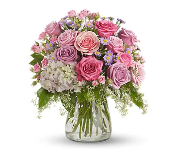 Pink and lavender rose bouquet in a clear glass vase