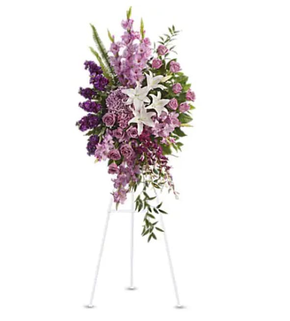 Tall purple and white floral standing spray on an easel