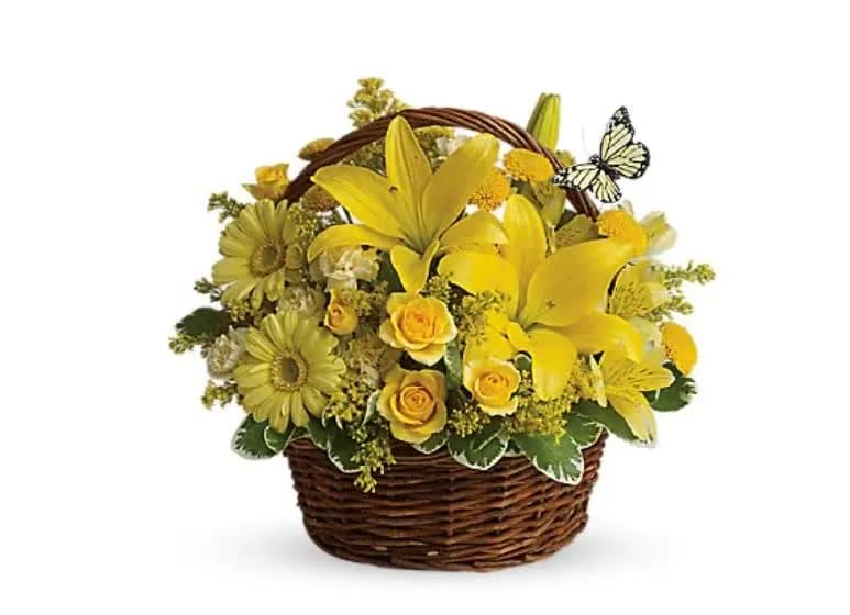 Yellow flowers arranged in a wicker basket with a butterfly accent