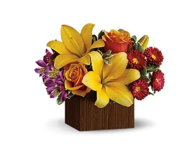 Full of Laughter - Arranged in a modern bamboo box, this stylish bouquet evokes the warm-hearted laughter of an island getaway. It's a cheerful choice for any occasion, from birthdays to hoorays! This chic arrangement features yellow asiatic lilies, orange roses, purple alstromeria and red matsumoto asters, accented with pretty pittosporum. Delivered in a modern rectangular vase crafted of real bamboo. 
