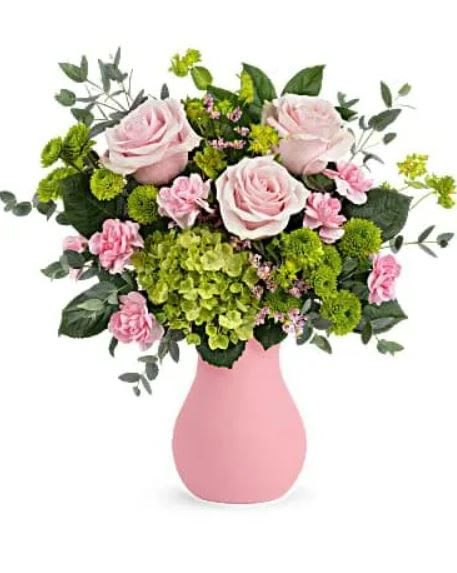 Breezy Pink Bouquet - Bursting from a frosted pink glass vase, this playful pop of pretty pink roses and fresh green hydrangea is as refreshing as a breezy spring day! This breezy bouquet includes pink roses, miniature green hydrangea, green button spray chrysanthemums, miniature pink carnations, pink limonium, bupleurum, parvifolia eucalyptus and lemon leaf. 