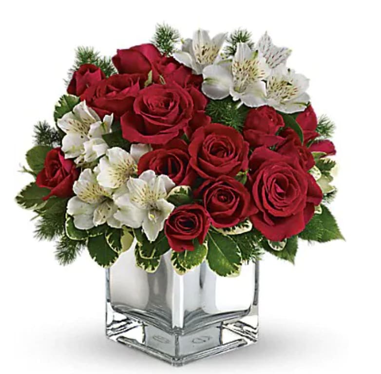 Red roses and white alstroemeria in a clear square vase