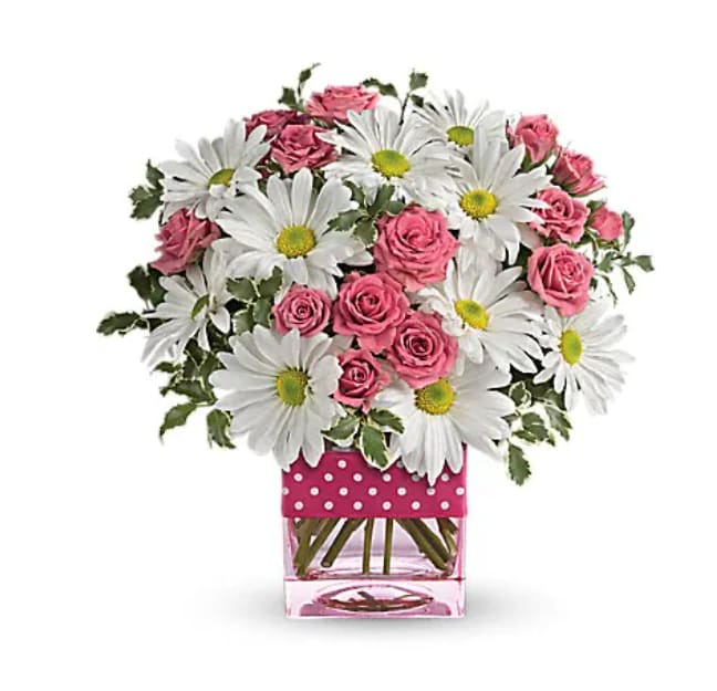 Polka Dots And Posies - Polka dots and posies, they're the perfect pair. Well, at least in this pretty arrangement they are. Just the right flowers in just the right vase all wrapped up in… you guessed it, just the right ribbon. Pink spray roses and white daisy spray chrysanthemums are delivered in an exclusive pink vase that's wrapped with a polka-dot satin ribbon.   Orientation : One-Sided  All prices in USD ($)  Standard  T52-3A  Deluxe  T52-3B  Premium  T52-3C
