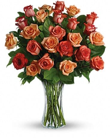 Sunrise Splendor - Send her a vase full of sunshine - glorious roses in brilliant shades of orange, light orange and dark orange. Delivered in a sparkling flared vase, this is a dazzling gift that will warm her heart for days - maybe weeks. This dazzling bouquet includes orange roses, light orange roses and dark orange roses accented with salal. Delivered in a flared glass vase. 