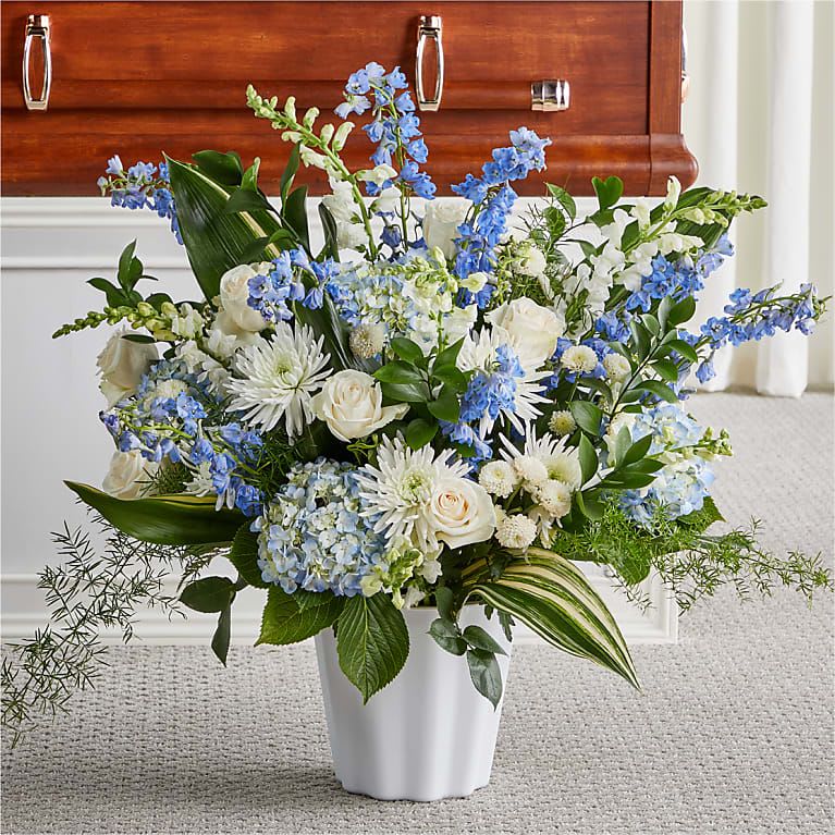 Everlasting Memories Floor Basket - A beautifully crafted arrangement of white and blue florals perfectly conveys your sympathy and comfort during a difficult time.  Bloom Details Delphinium Rose Hydrangea Snapdragon